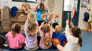 Preschool children enjoying an interactive music learning activity at Jacaranda Childcare Centre High Wycombe with colourful instruments and educator guidance.