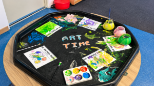 Children exploring creative art activities with paint at childcare