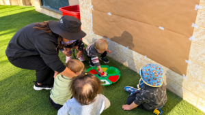 Children participating in a creative painting activity at childcare